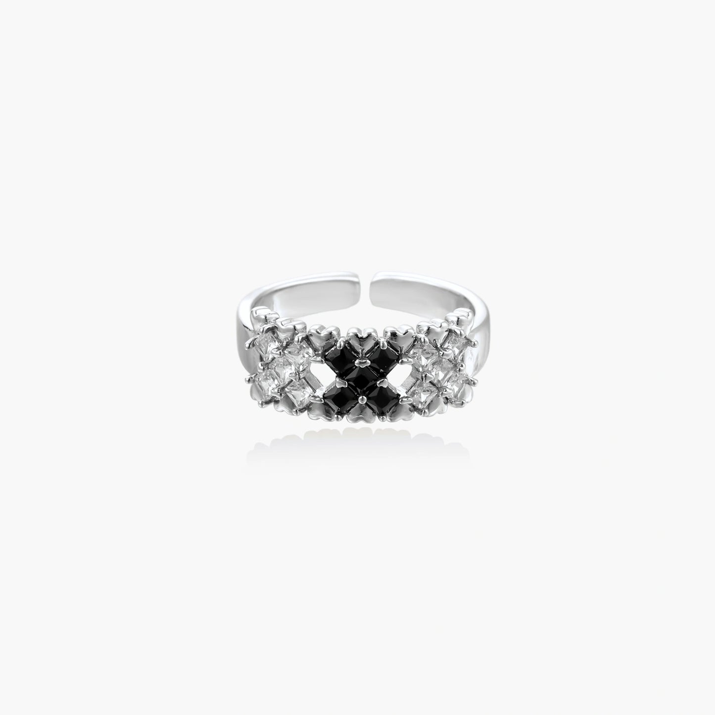 Adjustable white gold plated ring with geometric grid of black and clear zirconia stones in checkerboard pattern