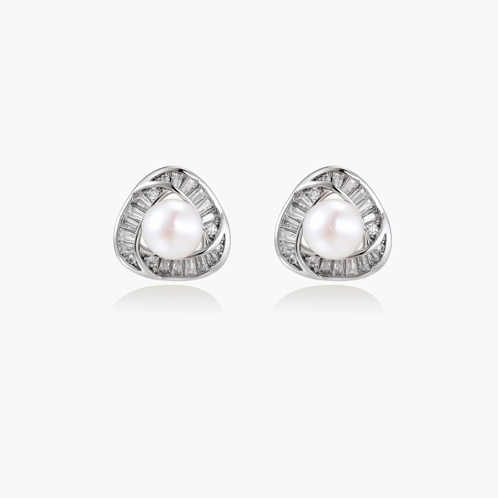 Triangular white gold plated stud earrings with central freshwater pearl and baguette-cut stones on white background