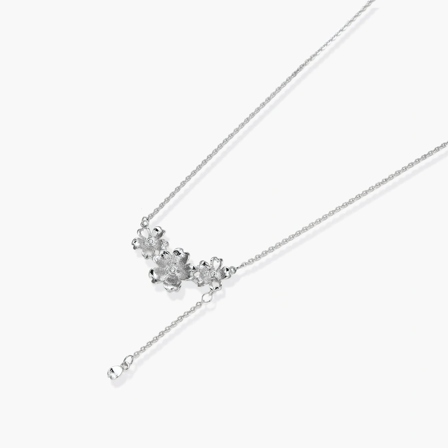 White gold plated Y-shaped necklace with three dimensional flower charms and adjustable drop pendant