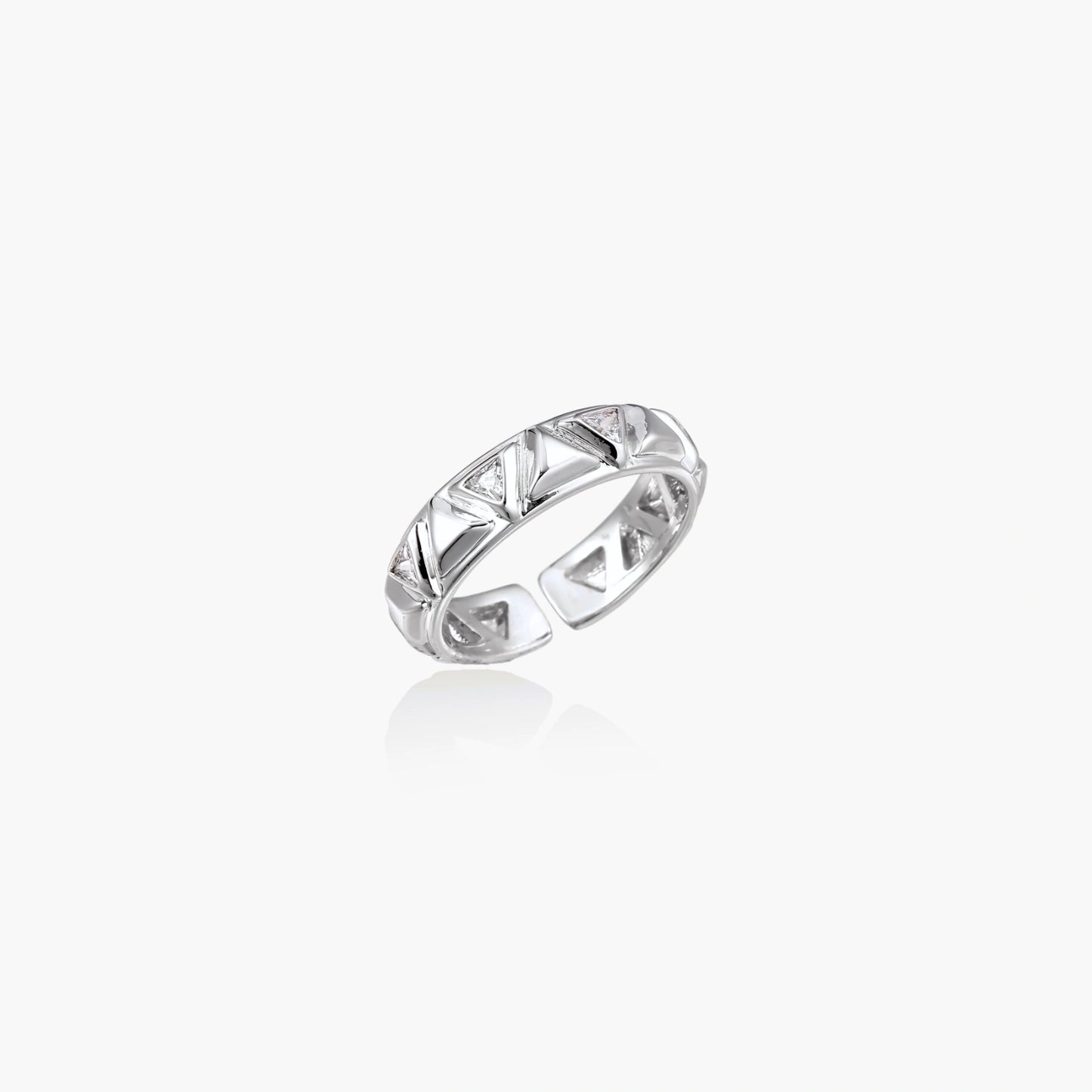 White gold adjustable ring with geometric triangle cutouts and zirconia stones on cream background