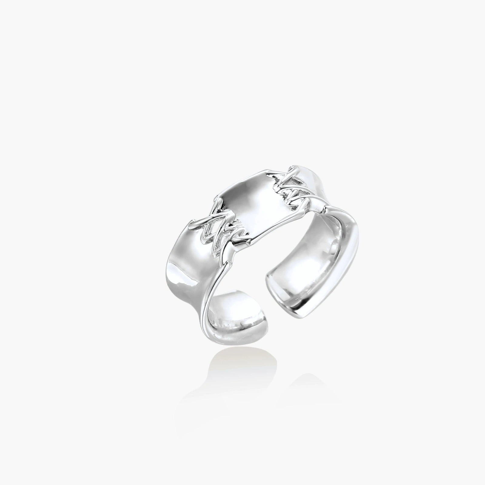 Adjustable silver-toned ring with sculptural stitch design across polished white gold-plated brass band