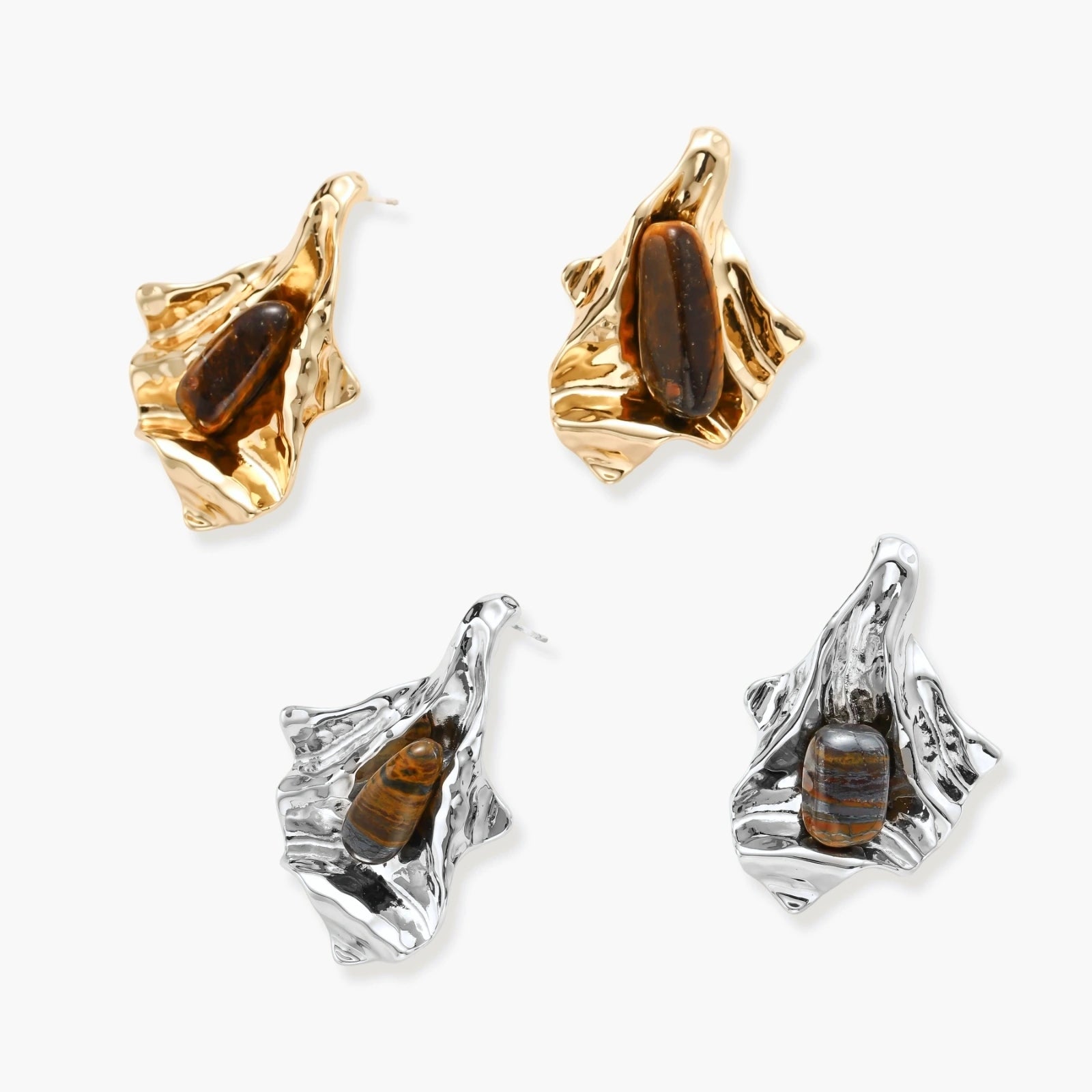 Sculptural gold-tone earrings with flowing organic forms and amber gemstone accents on neutral background