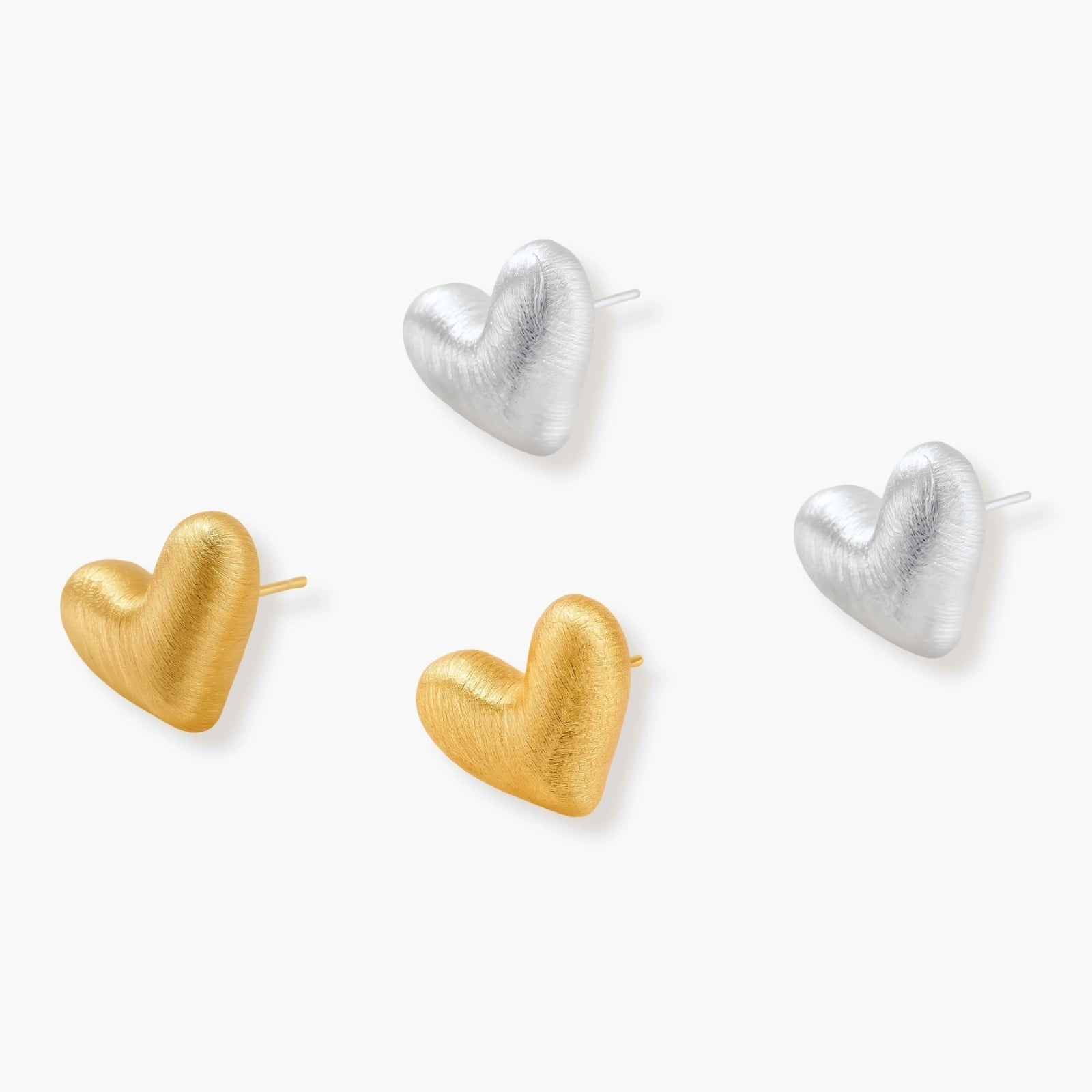 Pair of textured heart-shaped stud earrings in brushed platinum-plated sterling silver against cream background.