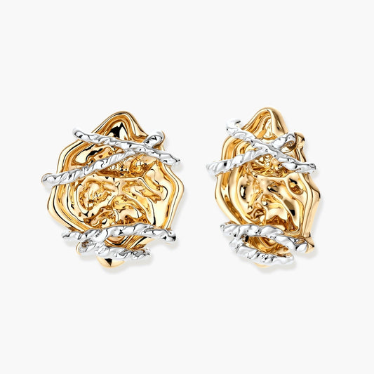 Sculptural rose-shaped stud earrings in gold with silver wire details and S925 posts on cream background.