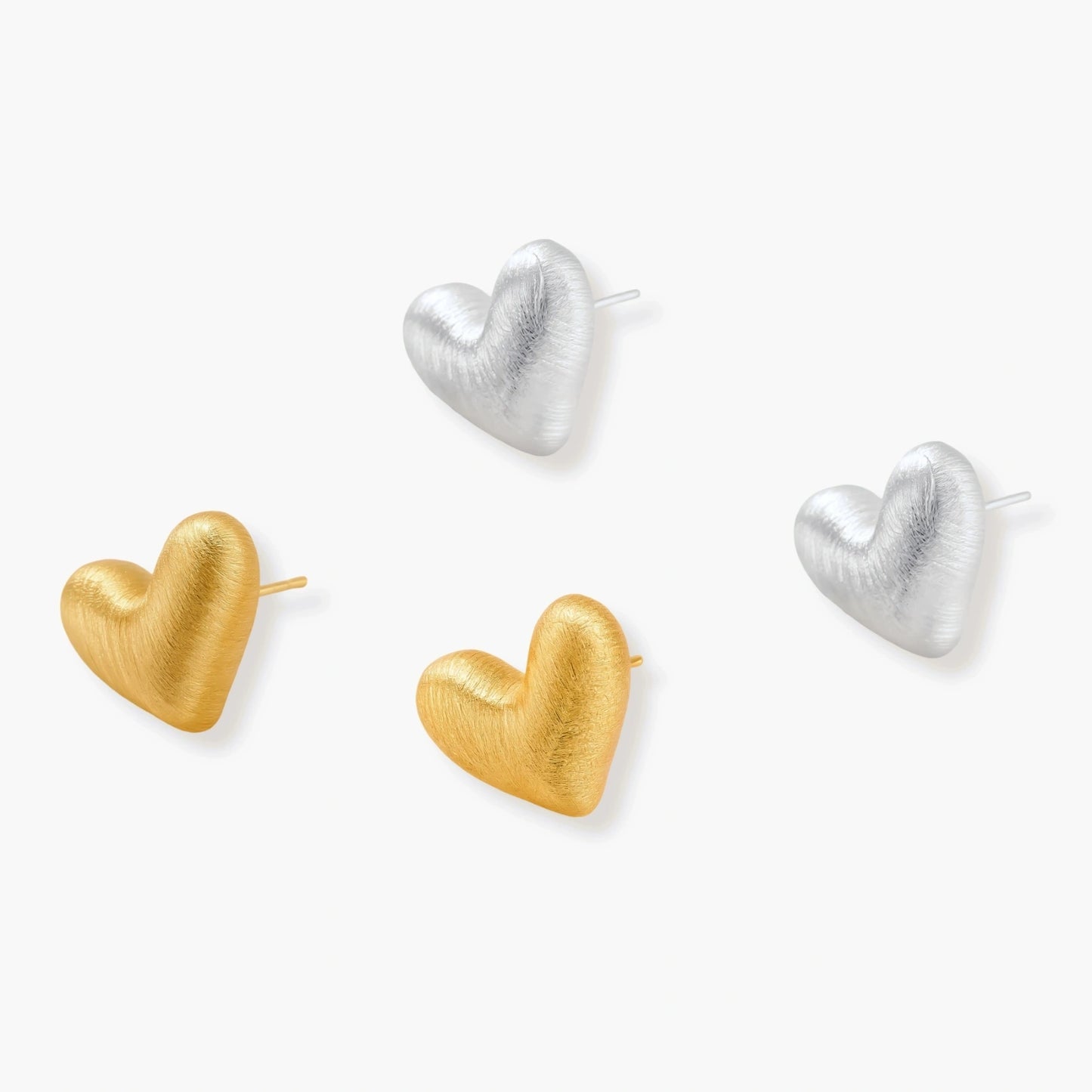 Pair of brushed platinum-plated 925 sterling silver puffy heart stud earrings on a cream background.